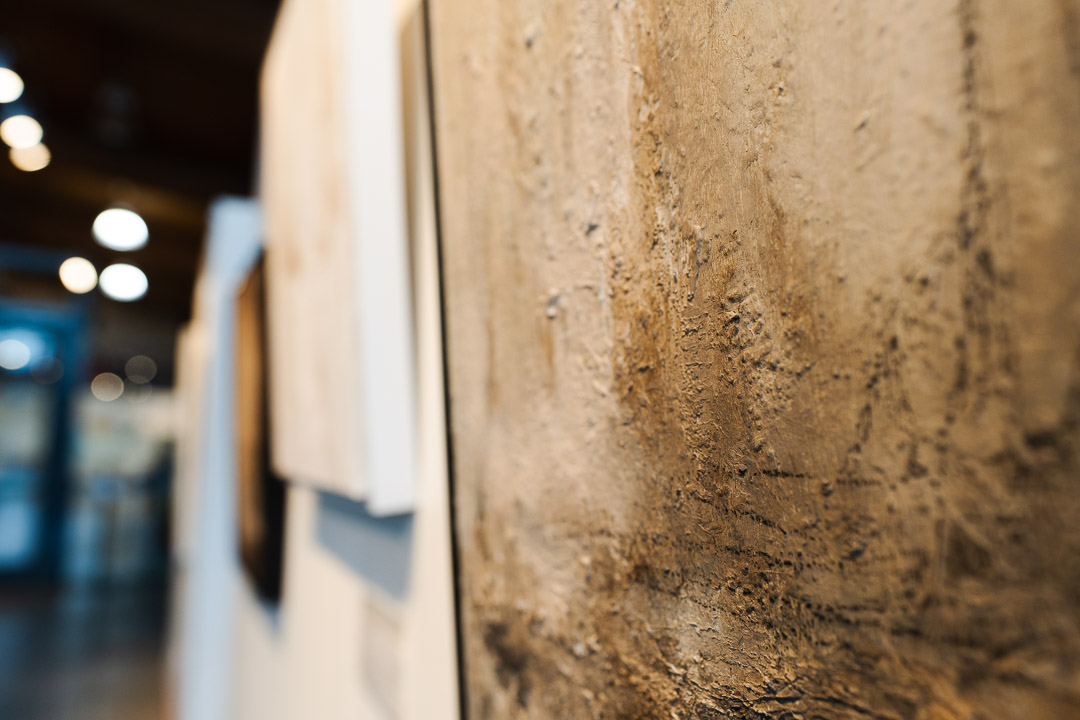 A close view of the architectural studies' textured surfaces and frames.