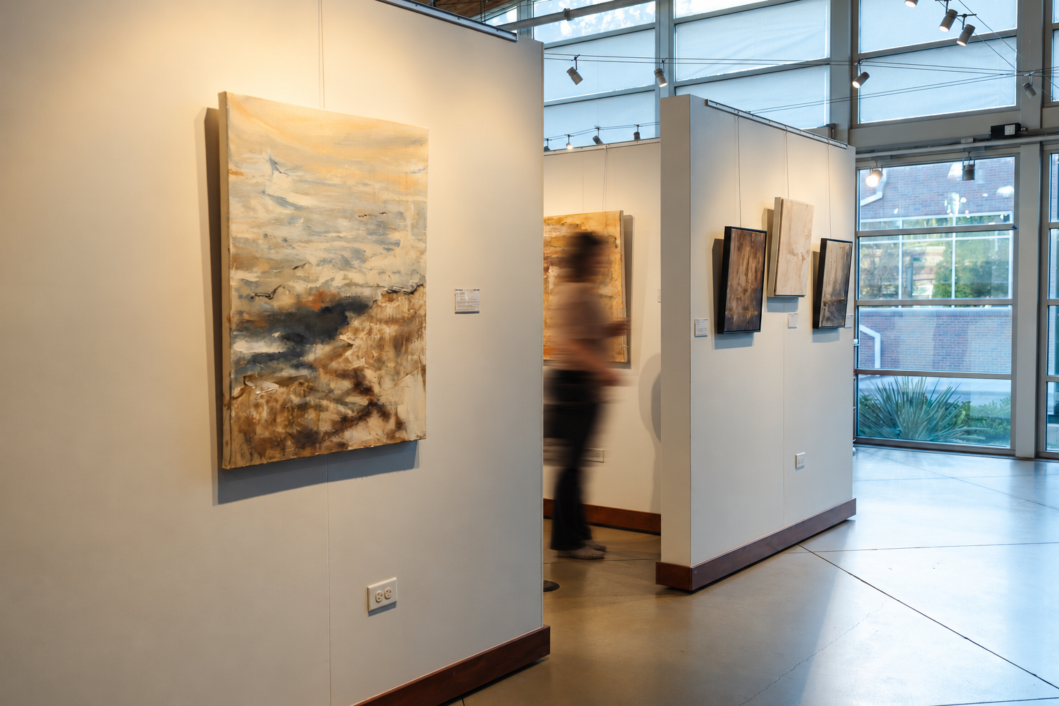 The Wild Sea and the architectural studies at Art Gym Denver, with a motion-blurred visitor.
